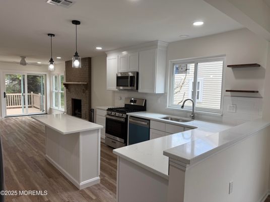 Fireplace, Interior, Kitchen, Pendant Lights, Recessed Lighting, Stainless Steel Appliances, Wood Texture Flooring