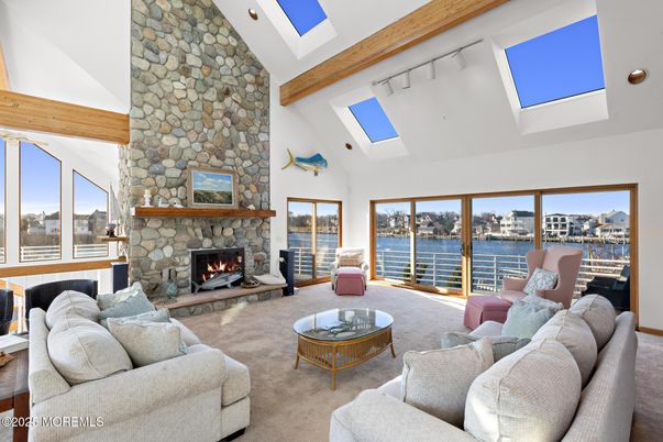 Fireplace, Interior, Living room, Recessed Lighting, Stone Walls, Water, Wooden Beams