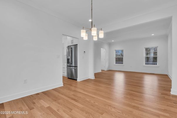 Empty room, Interior, Kitchen, Pendant Lights, Recessed Lighting, Stainless Steel Appliances, Wood Texture Flooring