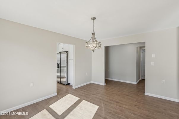 Chandelier, Empty room, Interior, Kitchen, Pendant Lights, Stainless Steel Appliances, Wood Texture Flooring