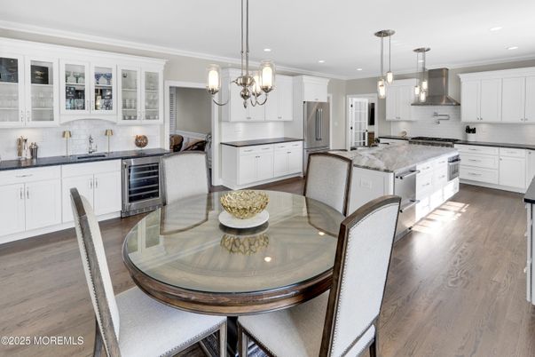 Chandelier, Dining room, Interior, Kitchen, Pendant Lights, Recessed Lighting, Stainless Steel Appliances, Wood Texture Flooring