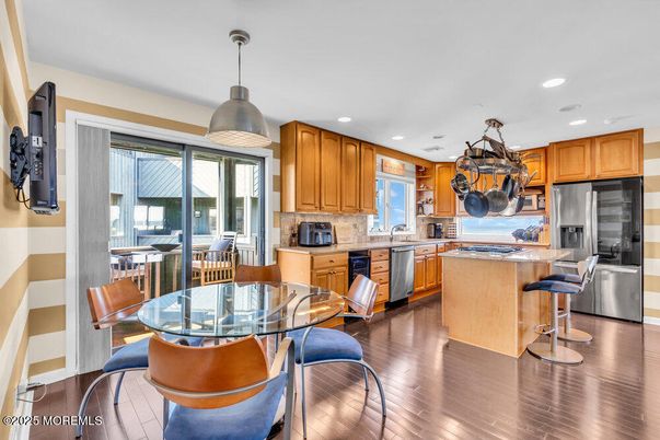Dining room, Interior, Kitchen, Pendant Lights, Recessed Lighting, Stainless Steel Appliances, Wood Texture Flooring