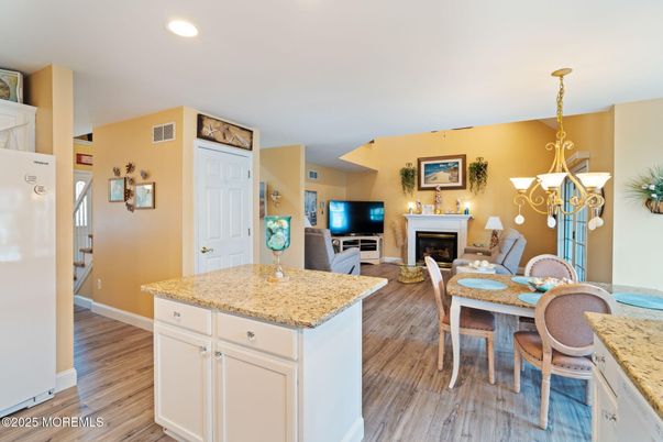 Chandelier, Dining room, Fireplace, Interior, Living room, Recessed Lighting, Wood Texture Flooring