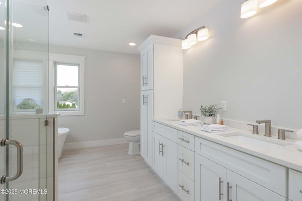 Bathroom, Dual Sink Vanities, Glass Shower, Interior, Recessed Lighting, Wood Texture Flooring