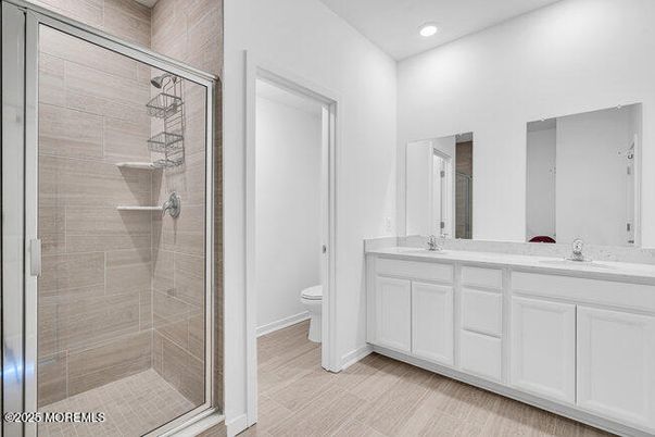 Bathroom, Dual Sink Vanities, Glass Shower, Interior, Recessed Lighting, Wood Texture Flooring