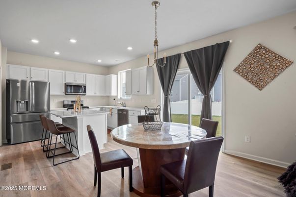 Dining room, Interior, Kitchen, Pendant Lights, Recessed Lighting, Stainless Steel Appliances, Wood Texture Flooring