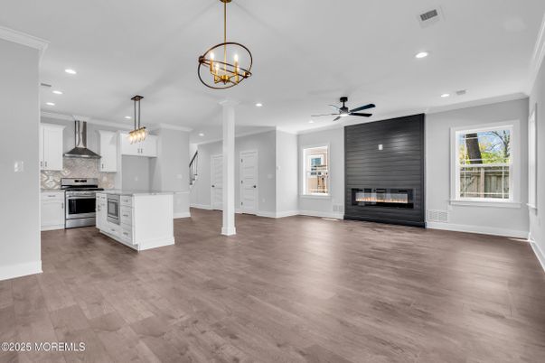 Empty room, Fireplace, Interior, Kitchen, Pendant Lights, Recessed Lighting, Stainless Steel Appliances, Wood Texture Flooring