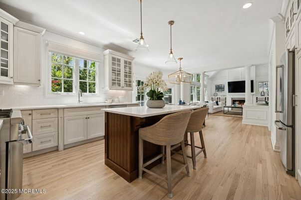 Fireplace, Interior, Kitchen, Living room, Pendant Lights, Recessed Lighting, Stainless Steel Appliances, Wood Texture Flooring