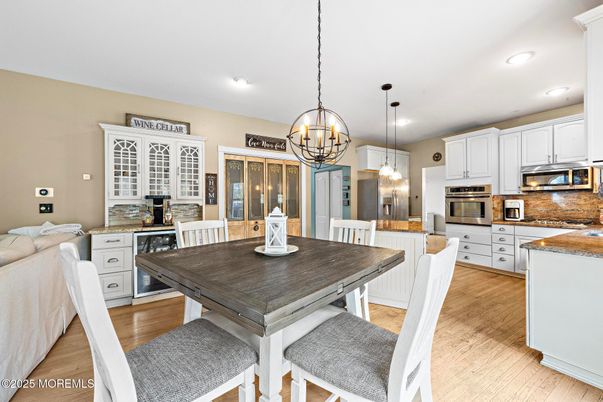 Chandelier, Dining room, Interior, Kitchen, Pendant Lights, Recessed Lighting, Stainless Steel Appliances, Wood Texture Flooring