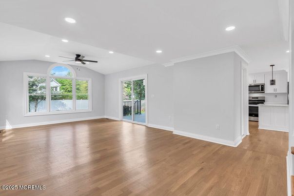 Empty room, Interior, Kitchen, Recessed Lighting, Stainless Steel Appliances, Wood Texture Flooring