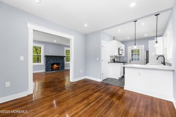 Empty room, Fireplace, Interior, Kitchen, Pendant Lights, Recessed Lighting, Wood Texture Flooring