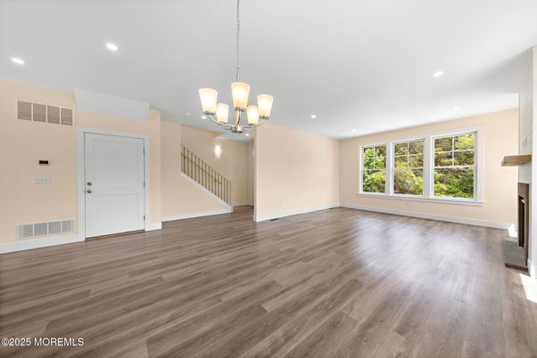 Chandelier, Empty room, Fireplace, Interior, Pendant Lights, Recessed Lighting, Wood Texture Flooring