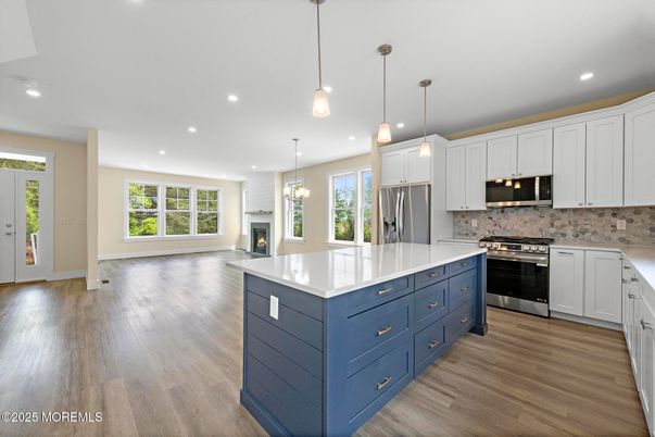 Fireplace, Interior, Kitchen, Pendant Lights, Recessed Lighting, Stainless Steel Appliances, Wood Texture Flooring