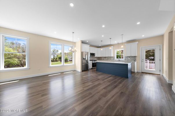 Empty room, Interior, Kitchen, Pendant Lights, Recessed Lighting, Stainless Steel Appliances, Wood Texture Flooring