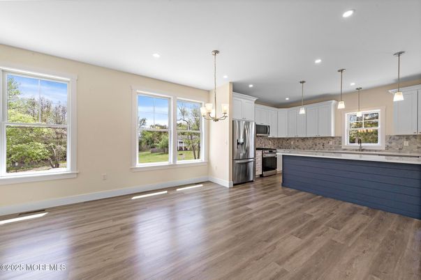 Chandelier, Empty room, Interior, Kitchen, Pendant Lights, Recessed Lighting, Stainless Steel Appliances, Wood Texture Flooring