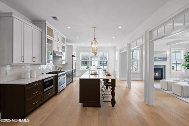 Chandelier, Dining room, Fireplace, Interior, Kitchen, Pendant Lights, Recessed Lighting, Stainless Steel Appliances, Wood Texture Flooring
