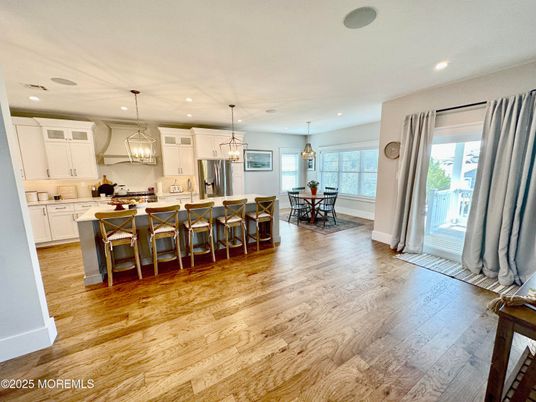 Chandelier, Dining room, Interior, Kitchen, Pendant Lights, Recessed Lighting, Stainless Steel Appliances, Wood Texture Flooring