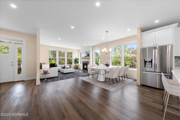Chandelier, Dining room, Fireplace, Interior, Kitchen, Living room, Pendant Lights, Recessed Lighting, Stainless Steel Appliances, Wood Texture Flooring