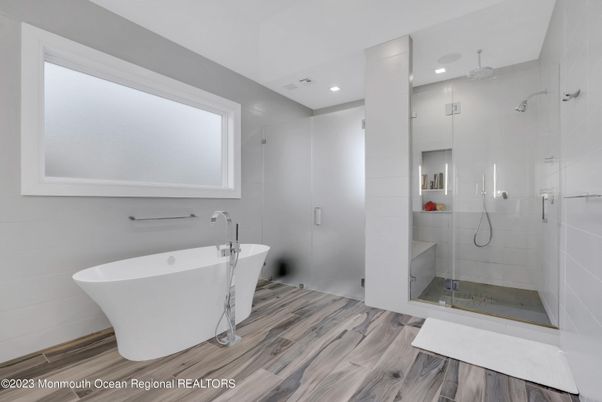 Bathroom, Free Standing Baths, Glass Shower, Interior, Recessed Lighting, Wood Texture Flooring
