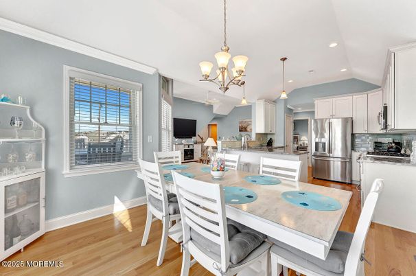 Chandelier, Dining room, Interior, Kitchen, Pendant Lights, Recessed Lighting, Stainless Steel Appliances, Wood Texture Flooring