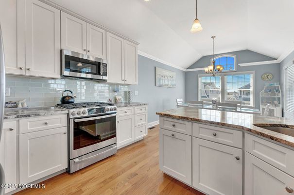 Chandelier, Dining room, Interior, Kitchen, Pendant Lights, Stainless Steel Appliances, Wood Texture Flooring