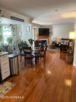 Dining room, Fireplace, Interior, Living room, Recessed Lighting, Wood Texture Flooring
