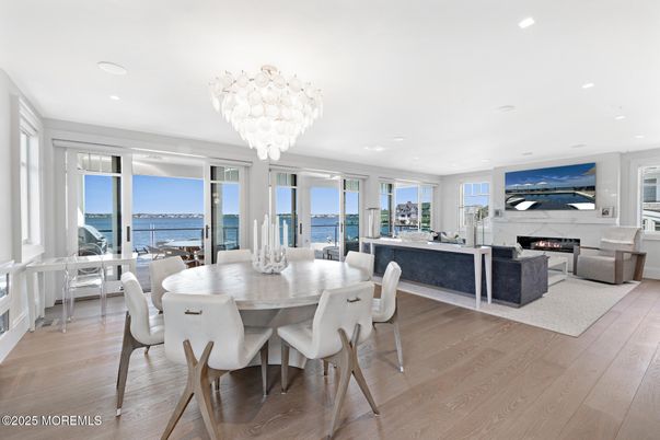 Chandelier, Dining room, Fireplace, Interior, Living room, Recessed Lighting, Water, Wood Texture Flooring