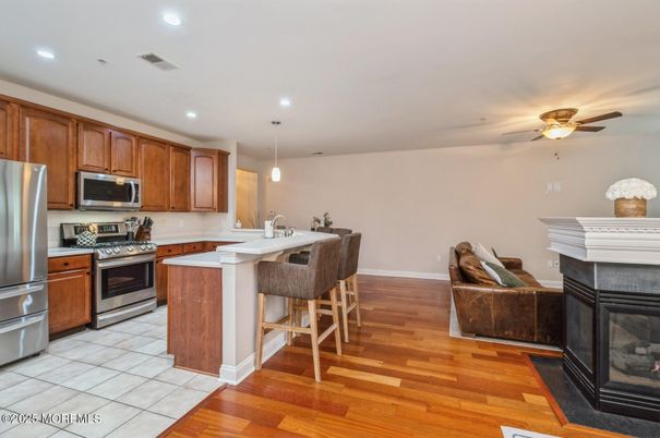 Fireplace, Interior, Kitchen, Pendant Lights, Recessed Lighting, Stainless Steel Appliances, Wood Texture Flooring