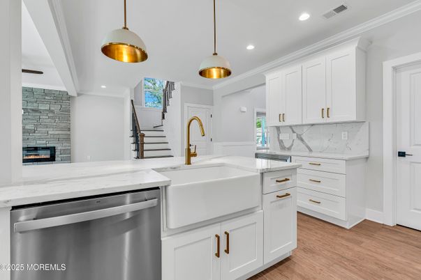 Fireplace, Interior, Kitchen, Pendant Lights, Recessed Lighting, Stainless Steel Appliances, Stone Walls, Wood Texture Flooring