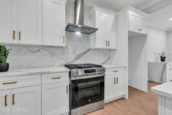 Interior, Kitchen, Marble Walls, Recessed Lighting, Stainless Steel Appliances, Wood Texture Flooring
