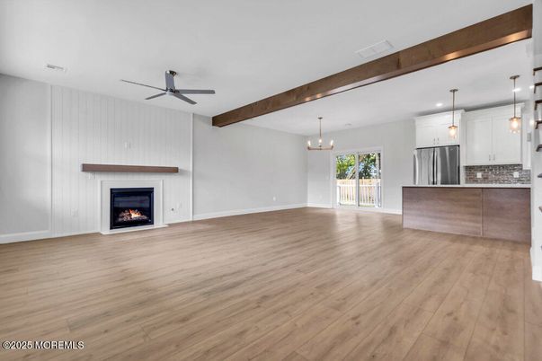 Empty room, Fireplace, Interior, Kitchen, Pendant Lights, Recessed Lighting, Stainless Steel Appliances, Wooden Beams, Wood Texture Flooring