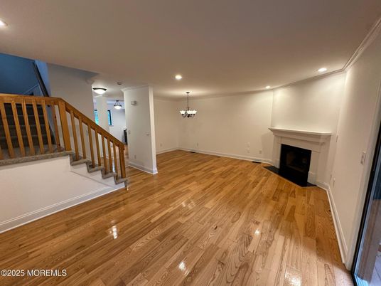Chandelier, Empty room, Fireplace, Interior, Recessed Lighting, Wood Texture Flooring
