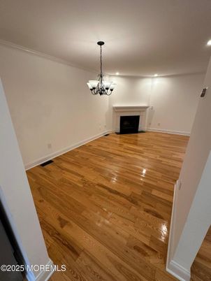 Chandelier, Empty room, Fireplace, Interior, Pendant Lights, Recessed Lighting, Wood Texture Flooring