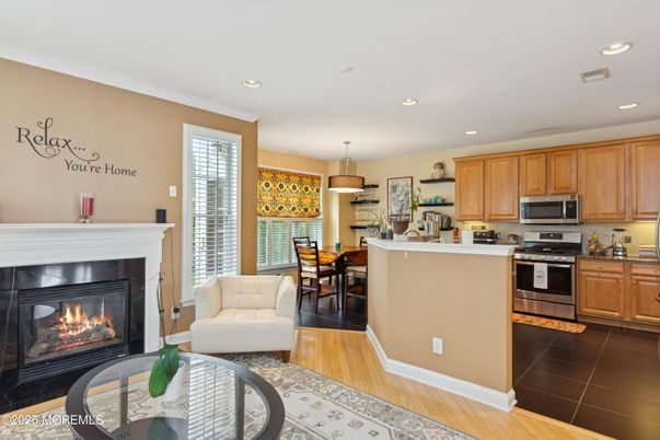 Dining room, Fireplace, Interior, Kitchen, Pendant Lights, Recessed Lighting, Stainless Steel Appliances, Wood Texture Flooring