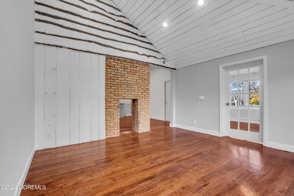 Empty room, Fireplace, Interior, Recessed Lighting, Stone Walls, Wood Texture Flooring