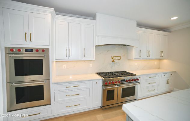 Interior, Kitchen, Marble Walls, Recessed Lighting, Stainless Steel Appliances, Wood Texture Flooring