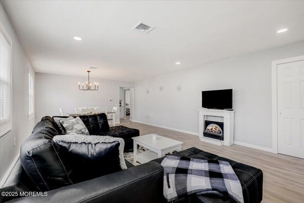 Chandelier, Dining room, Fireplace, Interior, Living room, Pendant Lights, Recessed Lighting, Wood Texture Flooring