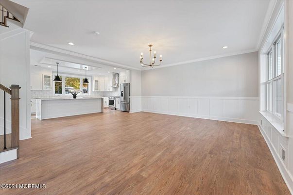 Chandelier, Empty room, Interior, Kitchen, Pendant Lights, Recessed Lighting, Stainless Steel Appliances, Wood Texture Flooring