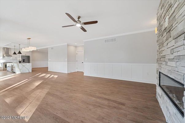 Empty room, Fireplace, Interior, Kitchen, Pendant Lights, Recessed Lighting, Stone Walls, Wood Texture Flooring