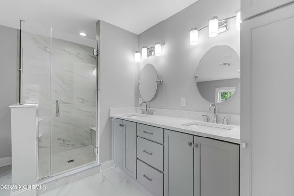 Bathroom, Dual Sink Vanities, Glass Shower, Interior, Marble, Marble Walls, Recessed Lighting