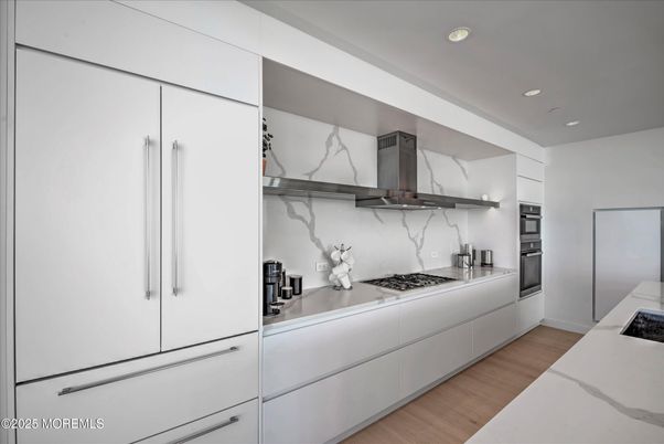 Interior, Kitchen, Marble Walls, Recessed Lighting, Stainless Steel Appliances, Wood Texture Flooring