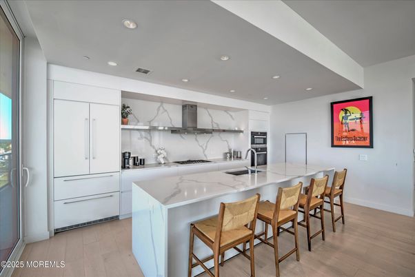 Interior, Kitchen, Marble Walls, Recessed Lighting, Stainless Steel Appliances, Wood Texture Flooring