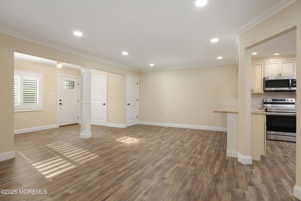 Empty room, Interior, Kitchen, Recessed Lighting, Stainless Steel Appliances, Wood Texture Flooring