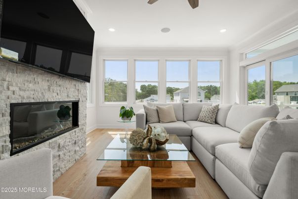 Fireplace, Interior, Living room, Recessed Lighting, Stone Walls, Wood Texture Flooring