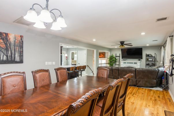 Chandelier, Dining room, Fireplace, Interior, Living room, Recessed Lighting, Wood Texture Flooring