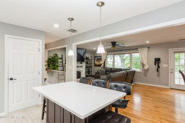 Dining room, Fireplace, Interior, Living room, Pendant Lights, Recessed Lighting, Wood Texture Flooring