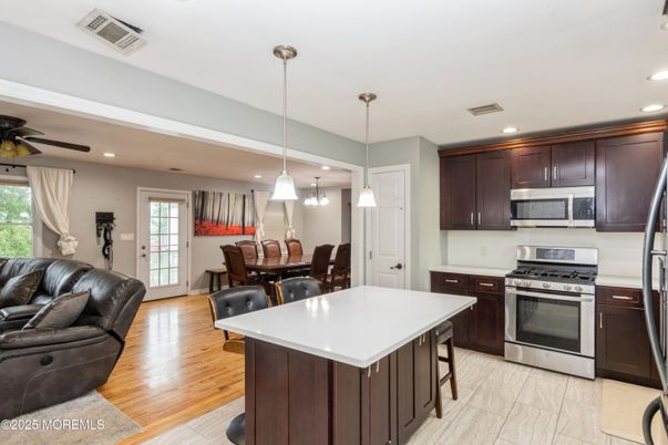 Dining room, Interior, Kitchen, Pendant Lights, Recessed Lighting, Stainless Steel Appliances, Wood Texture Flooring
