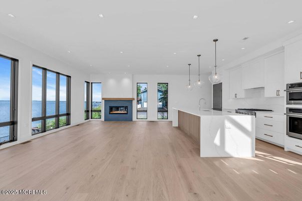 Fireplace, Interior, Kitchen, Pendant Lights, Recessed Lighting, Stainless Steel Appliances, Water, Wood Texture Flooring