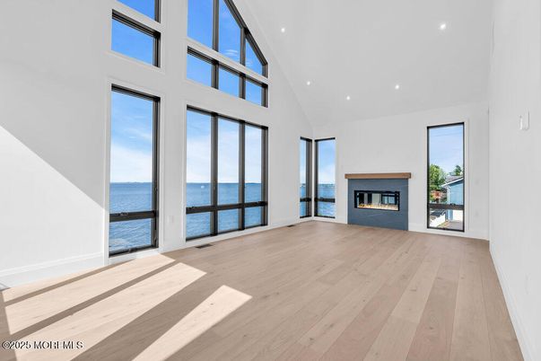 Empty room, Fireplace, Interior, Recessed Lighting, Water, Wood Texture Flooring