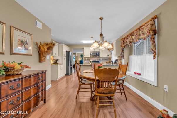 Chandelier, Dining room, Interior, Kitchen, Pendant Lights, Stainless Steel Appliances, Wood Texture Flooring